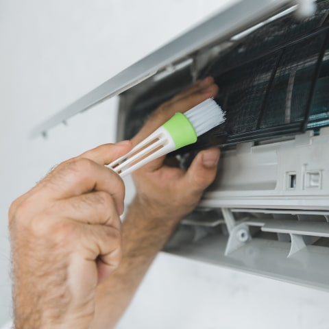 Cleaning an air conditioner filter during maintenance